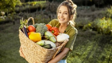 Woman carrying a basket of vegetables